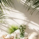 A fresh, minimal setup combining pale beach scenes, soft hued tropical plants, and playful summer icons.