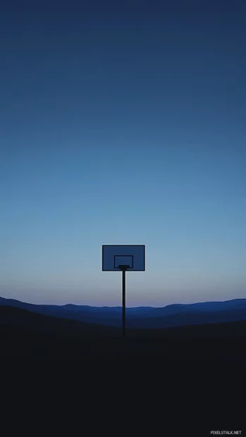 A solitary basketball hoop silhouetted at blue hour with subtle gradients.