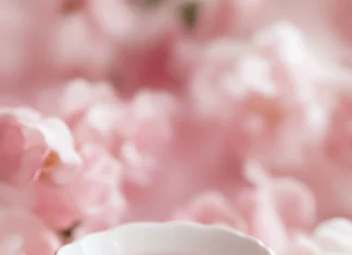 A vintage tea set surrounded by hearts in pink wallpapers for girls aesthetic style.