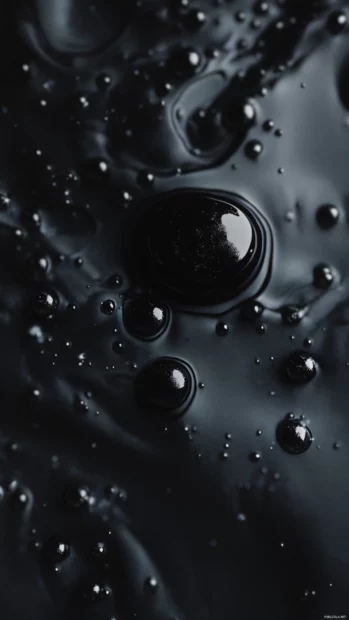 Abstract black ink drops floating in dark water.