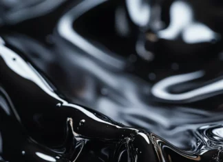 Abstract black liquid ripples forming sharp edgy patterns.