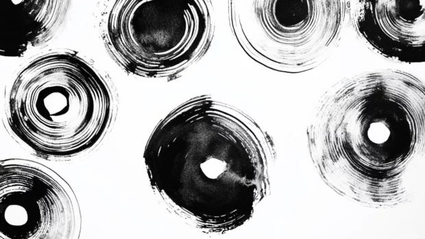 Abstract circular patterns created with bold black and white watercolor strokes.