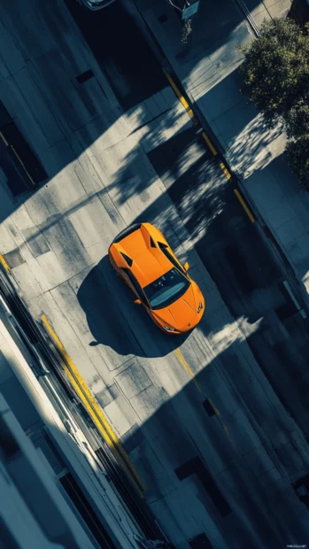 Aerial perspective of Lamborghini framed by sharp city shadows.