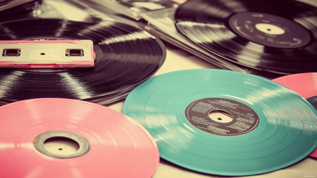 An elegant pattern of vintage vinyl records and cassette tapes, layered on a textured background that evokes a nostalgic music vibe, with soft pastel colors.