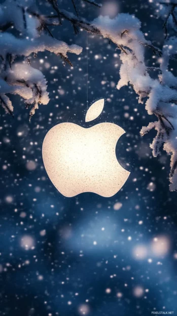 Apple logo shining subtly under delicate falling snow.