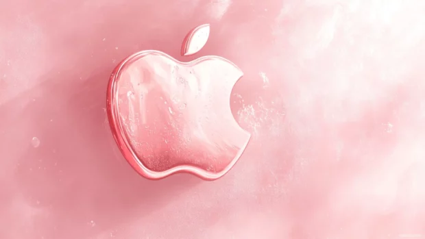 Apple symbol resting on a dreamy pink canvas with a soft glow radiating outward.