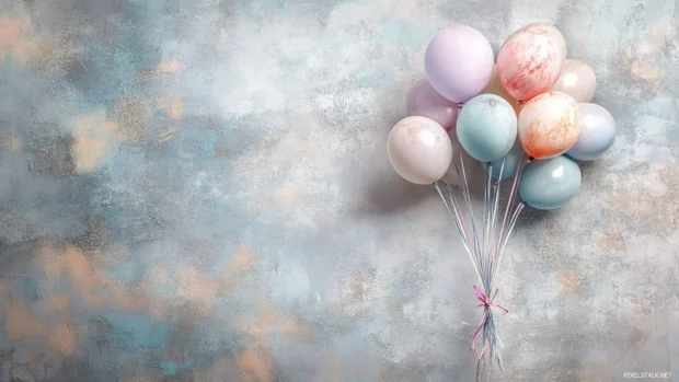 Balloon bouquet in soft pastels against textured backdrop.