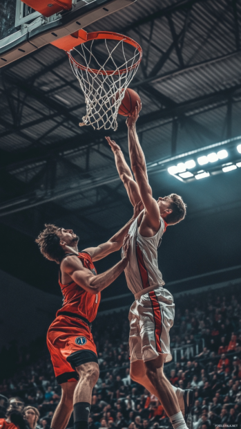Basketball match freeze frame with powerful jump block.
