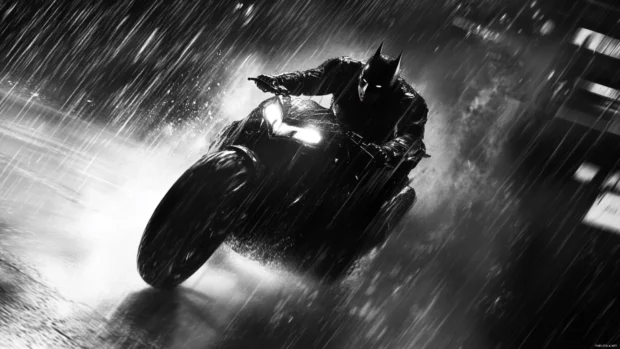 Batman riding the Batcycle through rain at high speed.