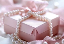 Beautifully wrapped pink gift box with satin ribbon and pearls.