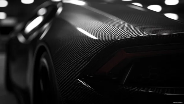 Black Lamborghini wallpaper presenting carbon fiber textures under focused lighting.