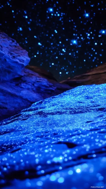 Blue stars illuminating quiet desert dunes.
