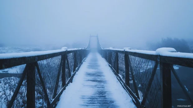 Bridge crossing a snow covered ravine.