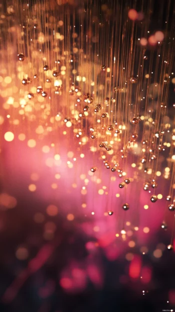Bright particles cascading like waterfalls of light.