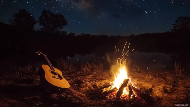 Campfire flickering beside a steel guitar under stars.