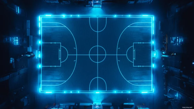 Cinematic top down shot of a symmetrical basketball court lit by blue LEDs.
