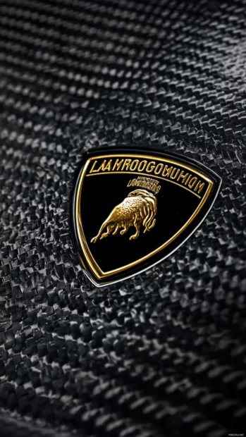 Close up of Lamborghini Aventador badge against carbon fiber texture.