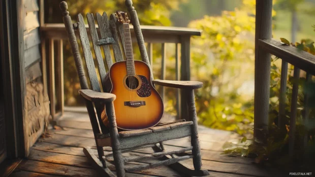 Country music guitar resting on a rocking chair by the porch.