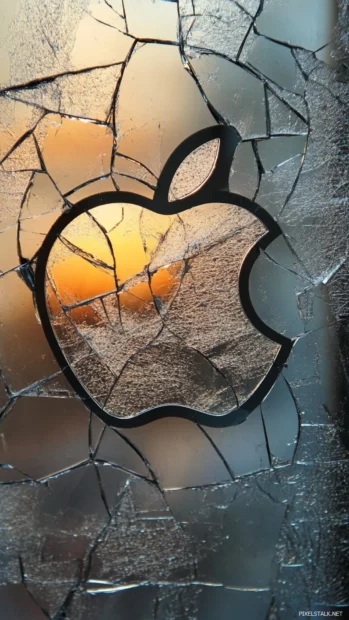 Cracked Apple logo on broken mirror surface.