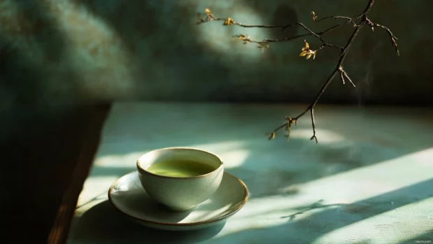 Cup of matcha tea, aesthetic composition, soft lighting.