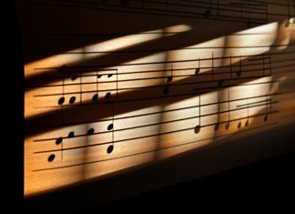 Detailed music notes on musical staff under sunlight with soft window shadows.