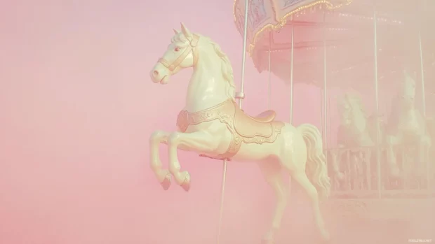 Dreamy carousel horse in a light pink fog.