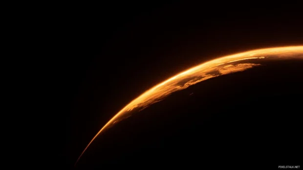 Eclipsed sun casting glow behind the Earths edge.