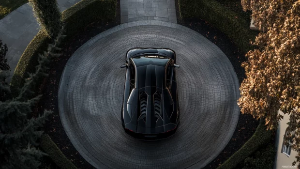 Editorial Black Lamborghini PC wallpaper featuring an aerial view of the car at a circular driveway.