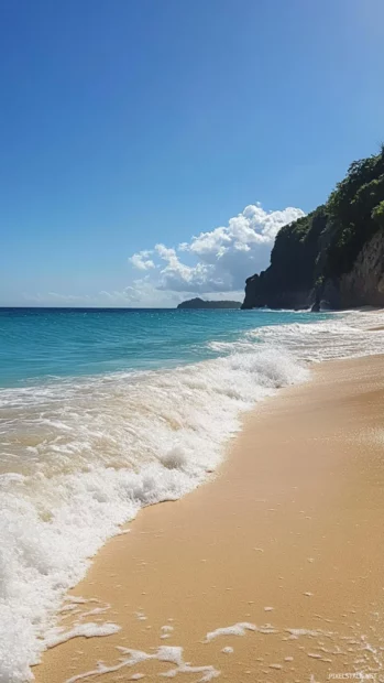 Gentle waves washing onto a sandy beach.