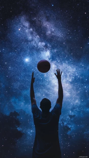 Low angle basketball hero pose with ball and starry sky backdrop.