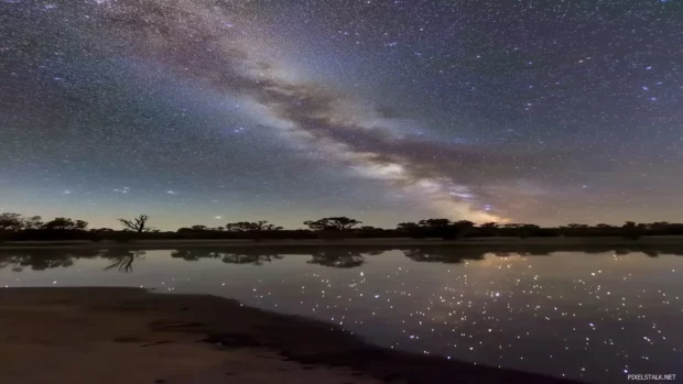 Mesmerizing starry sky, twinkling stars, prominent Milky Way, dark blue expanse, wonder tranquility.