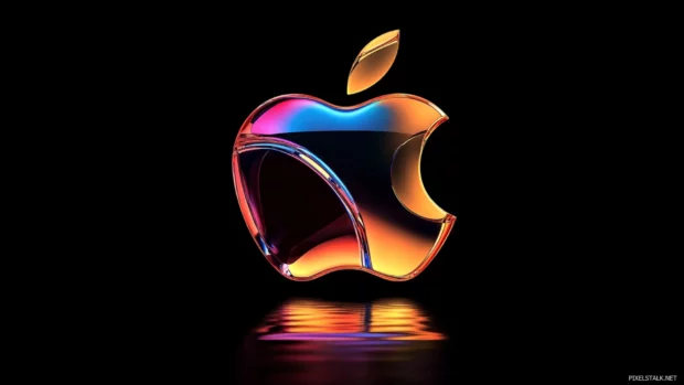 Metallic Apple logo highlighted by reflective light effects on dark base.