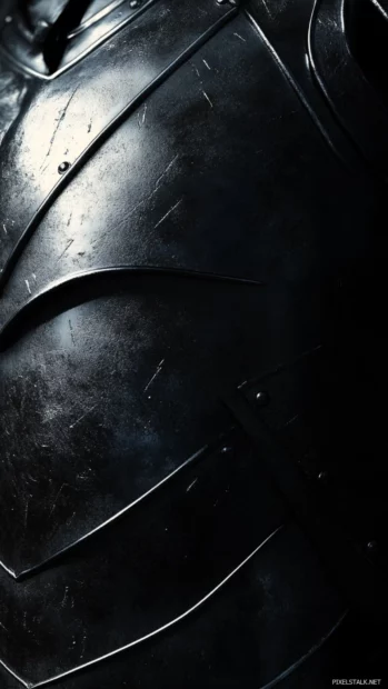 Metallic black armor texture under dramatic shadows.