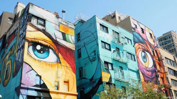 Metropolitan cityscape with building faces painted in street art.