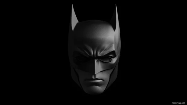 Minimalist Batman mask against plain dark background.