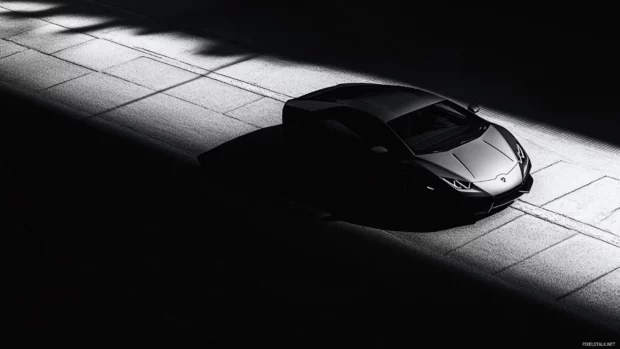 Minimalist Black Lamborghini wallpaper with soft gradients and sharp shadows on pavement.