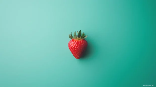 Minimalist design with a single strawberry at the center of a soft pastel green background, clean, simple, and elegant.