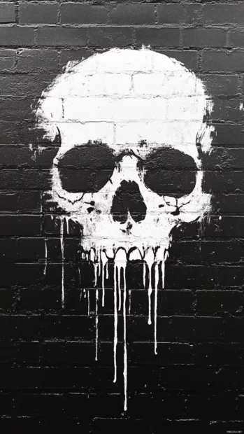 Painted skull dripping white against grunge brick wall.