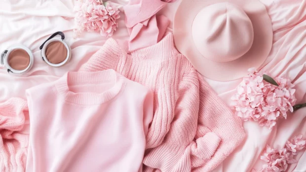 Pink Girly fashion pieces laid out on pastel bedding.