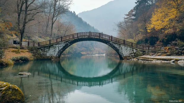 Pretty bridge arching over quiet riverbank.