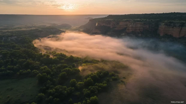 Pretty mist hovering above sunrise valley.