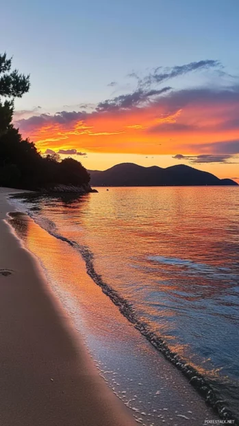 Pretty sunset reflecting on serene beach.