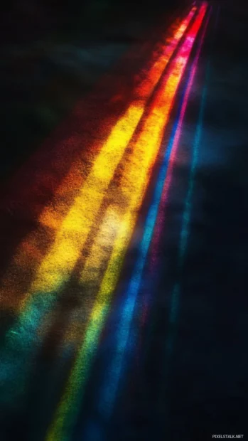 Rainbow light beams spreading softly across a dark canvas.