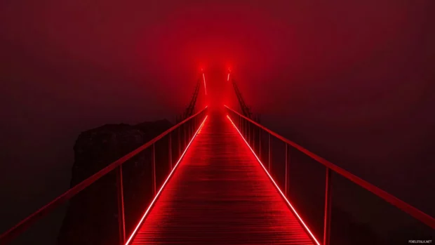 Red neon bridge stretching across endless abyss.