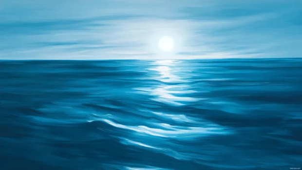 Reflection of moonlight dancing across calm ocean waves.