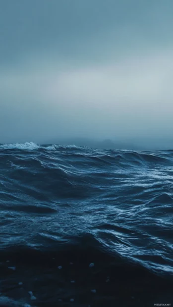Relaxing Moving Wallpapers for Android with ocean waves rolling under moonlight.