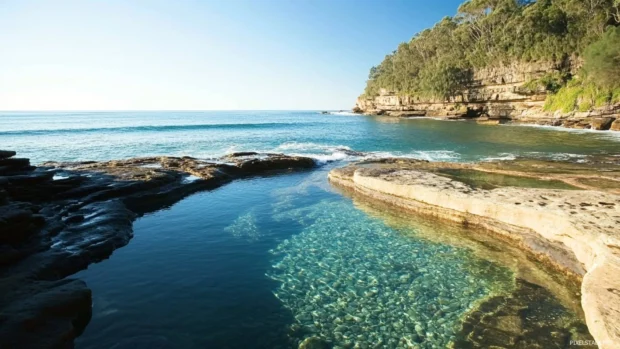 Rock pools sparkling beside Pretty Ocean rocks.