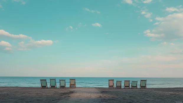 Rows of beach chairs facing the horizon, ready for long, peaceful afternoons.