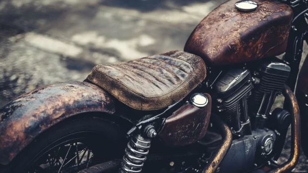 Rustic Harley Davidson with worn leather seat, ultimate Harley Davidson PC wallpaper aesthetic.