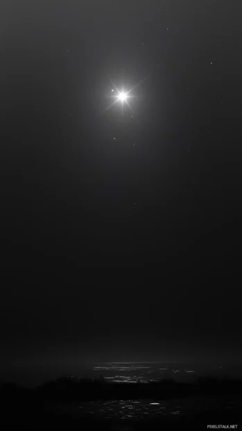 Shining in the vast darkness of space, a single bright white star is surrounded by a subtle aura of light, creating a minimalist and peaceful night sky.